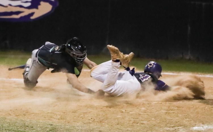 Suwannee catcher Jace Moran tags out Columbia second baseman Trayce McKenzie at home plate on Thursday. (BRENT KUYKENDALL/Lake City Reporter)