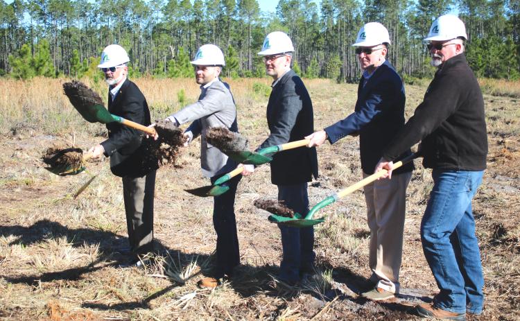 AgroLiquid adminstrators David Gilliam (from left), Gerrit Bancroft, Nick Bancroft, Alan Kennedy and Todd Cressman toss dirt from their shovels during  Tuesday morning’s groundbreaking ceremony for the new AgroLiquid plant at the North Florida Mega Industrial Park. (TONY BRITT/Lake City Reporter)