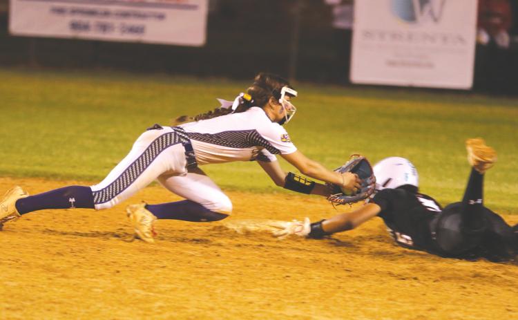 Columbia shortstop Lillyenne Mayhew applies a late tag to Baldwin shortstop Amiyah Jones during the Tigers’ 9-0 loss on Friday. (MORGAN MCMULLEN/Lake City Reporter)