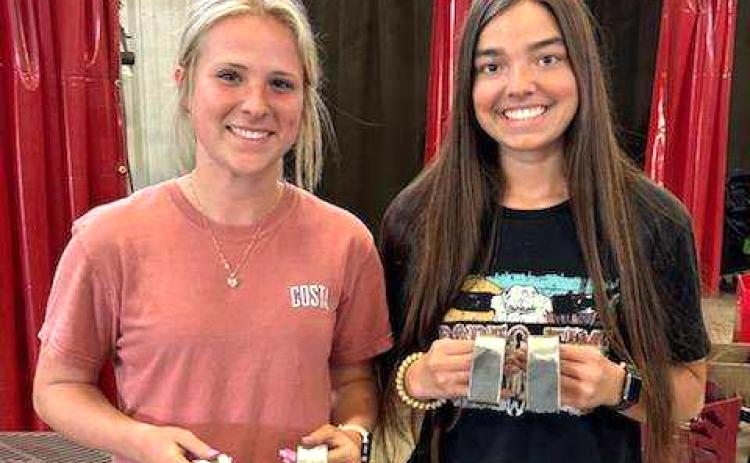 CHS welders Karsyn Sims (left) and Madison Bailey became the first female students at CHS to earn their welding certificates after passing their tests Tuesday. (COURTESY)