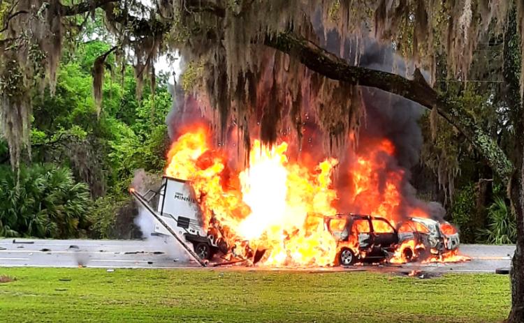 Two SUVs and a travel trailer burst into flames Friday evening on State Road 136 near the State Farmer’s Market in White Springs. A Lake City man was killed in the crash. (GLENN ALLEN/Special to the Reporter)