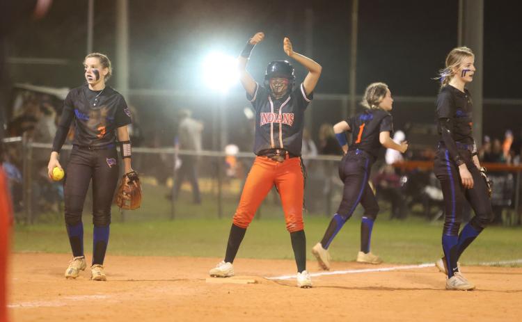 Fort White’s Jermauni Byrd celebrates on third base between Branford shortstop Cloey Criggall and third baseman Madyson Sikes on Friday. (PAUL BUCHANAN/Special to the City Reporter)