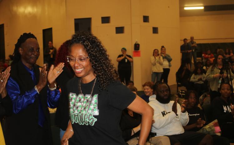 Richardson Sixth Grade Academy teacher Keisha Kimble was all smiles as she’s called up to receive a certificate from the district Friday for the statewide Excellence in Education award she received earlier in the week. (TONY BRITT/Lake City Reporter)