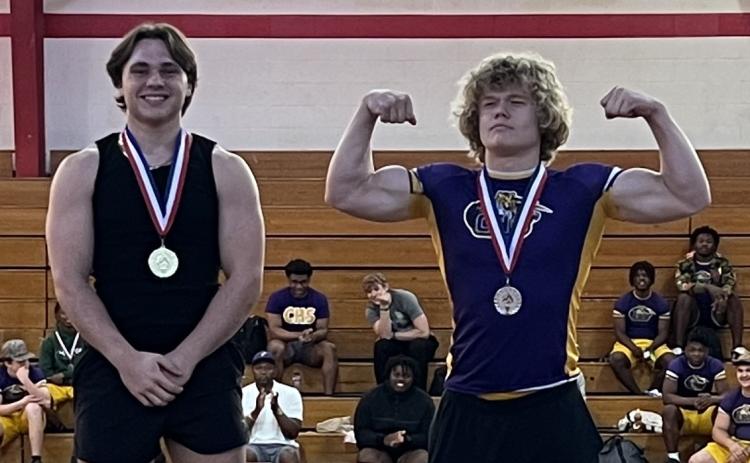 Columbia lifters Tyson Yaxley (left) and Garrett Shipley (right) celebrate on the podium after placing first and second at the District 3-2A meet on Thursday. (COURTESY)