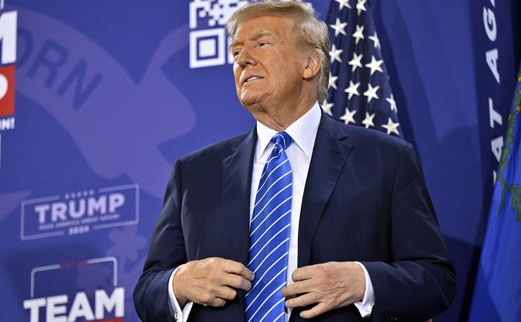 Republican presidential candidate and former U.S. President Donald Trump stands on stage during a campaign event at Big League Dreams Las Vegas on Jan. 27. (DAVID BECKER/Getty Images/TNS)