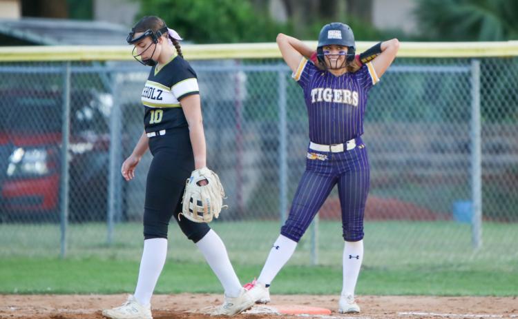 Columbia shortstop Lillyenne Mayhew smiles at first base after reaching on a single against Buchholz on Thursday. (BRENT KUYKENDALL/Lake City Reporter)