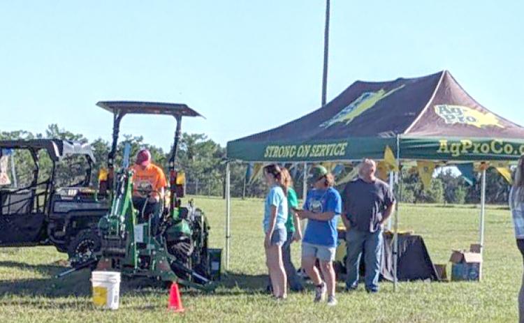 Kids Feeding Kids Ag Expo participants line up for a turn on some farm equipment during last weekend’s event. (COURTESY)