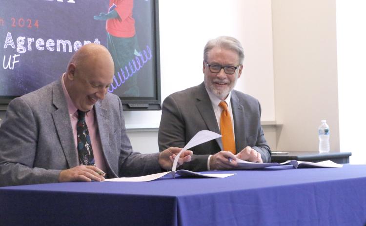 Florida Gateway College President Larry Barrett (left) and David Richardson, the dean of the College of Liberal Arts and Sciences at the University of Florida, signed an articulation agreement Thursday that guarantees FGC graduates with admission into 17 degree programs at UF’s liberal arts college. (MORGAN MCMULLEN/Lake City Reporter)