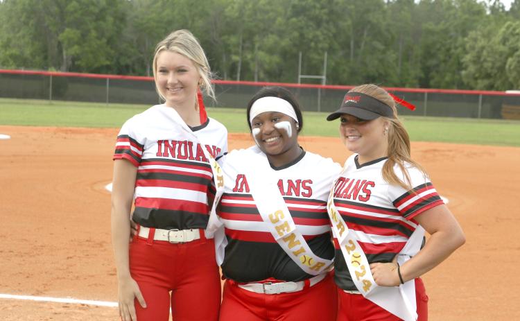 Fort White seniors Carly Caines (from left), N'Coreyia Atkins and Gracie Clemons pose ahead of Thursday's game against Dixie County. (MORGAN MCMULLEN/Lake City Reporter)