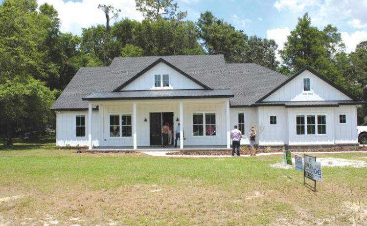 Folks wait to take a tour of one of the houses on the 2022 Parade of Homes route. (FILE)