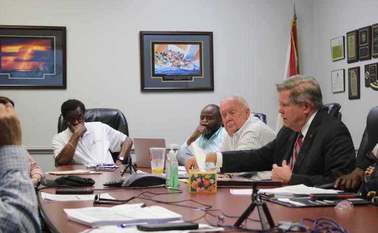 Robert Jones (from left), CareerSource Florida Crown Executive Director, Ron Jones, and Eugene Dukes, board chairman, listen intently as Guy Norris, Florida Crown legal counsel, talks about recent economic sanctions applied to the agency during the Wednesday morning’s CareerSource Florida Crown board meeting. (TONY BRITT/Lake City Reporter)