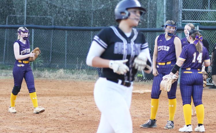 Columbia pitcher Harleigh Price gets some encouragement from teammate Alex Collins (14) as Gainesville’s Braylin Cook makes her way around the bases after a home run during Tuesday’s District 2-5A semifinal. (MORGAN MCMULLEN/Lake City Reporter)