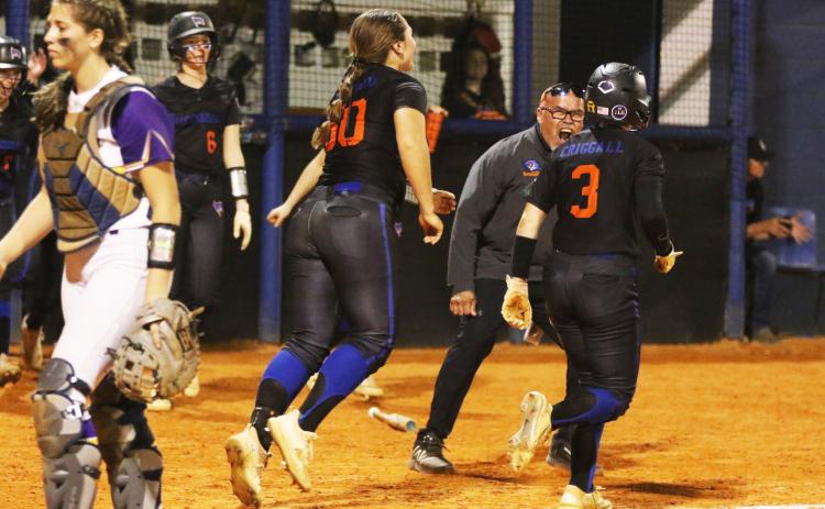 Branford coach Oscar Saavedra celebrates with Cloey Criggall after she scored the game-winning run against Bell on Friday. (MORGAN MCMULLEN/Lake City Reporter)