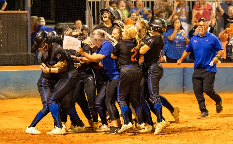 Branford's softball team celebrates with Mallory Blue at home plate after she scored the game-winning run in extra innings to defeat Aucilla Christian in the Region 3-1A semifinals on Thursday. (JACK HOWDESHELL/Special to the Reporter)