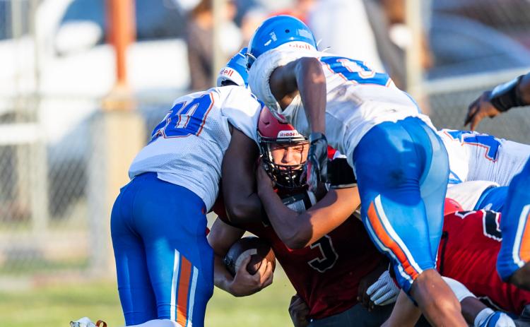Lafayette running back Dayne McCray is tackled by a group of Taylor County defenders during Thursday's spring game. (JACK HOWDESHELL/Special to the Reporter)