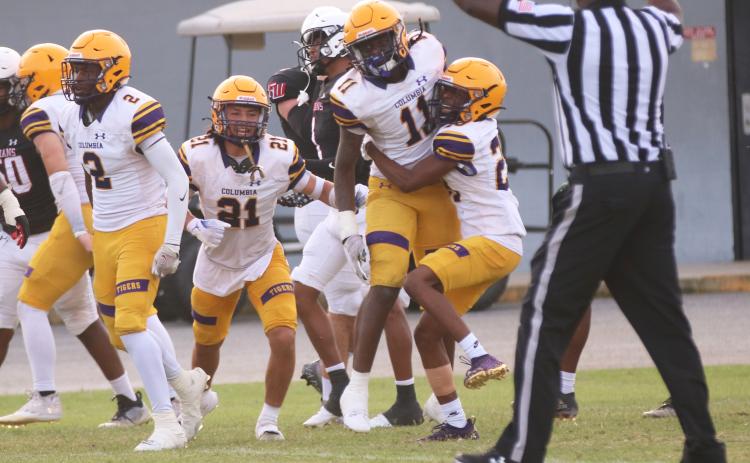 Columbia linebacker Dajon Brown celebrates with defensive backs Julian De La Cruz (21) and Mekah Combs-Turner (right) after his interception during Friday’s spring game against Fort White. (JORDAN KROEGER/Lake City Reporter)
