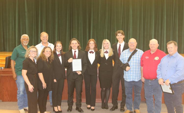 County Commissioners Ron Williams (from left) and Robby Hollingsworth stand with members and advisors for the Fort White High School HOSA parlimentarian team Christan Higginbotham, Ashley Blanton, Kamryn Cembruch, Trace Taylor, Jayda Plasencia, Clara Robinson, Kenton Hassee and Commissioners Rocky Ford, Everett Phillips and Tim Murphy. (TONY BRITT/Lake City Reporter)
