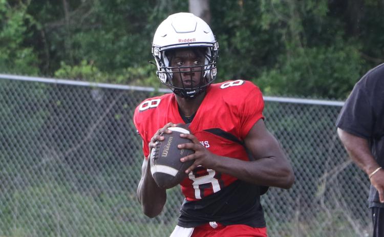 Fort White quarterback Jayden Jackson rolls out to pass during practice on May 1. (MORGAN MCMULLEN/Lake City Reporter)