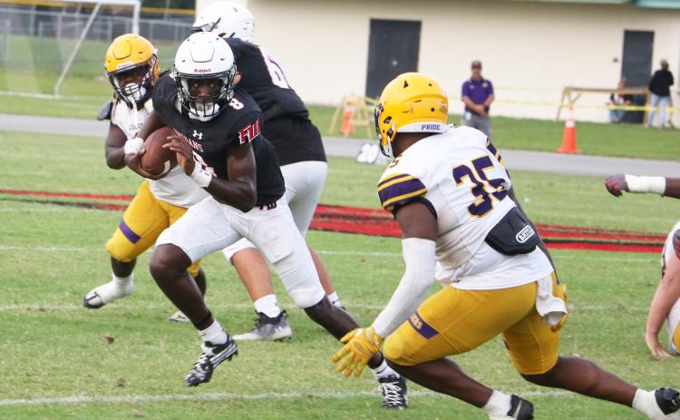 Fort White quarterback Jayden Jackson scrambles up the field as Columbia linebacker Chris Jordan runs in for a tackle during the teams’ spring game on May 17. (MORGAN MCMULLEN/Lake City Reporter)