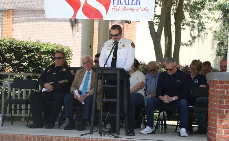 Lake City Fire Chief Josh Wehinger addresses the crowd as local and religious leaders listen during Thursday’s National Day of Prayer. (MORGAN MCMULLEN/Lake City Reporter)