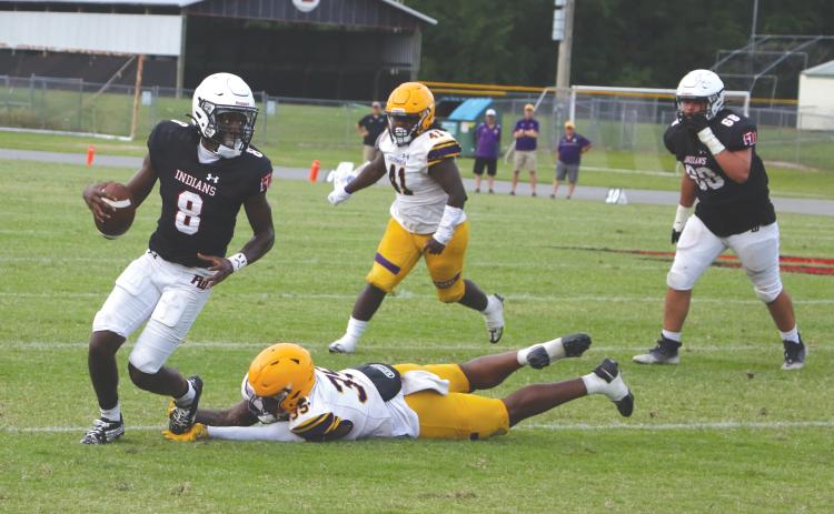 Fort White quarterback Jayden Jackson scrambles away from pressure from Columbia linebacker Chris Jordan during Friday's spring game. (MORGAN MCMULLEN/Lake City Reporter)
