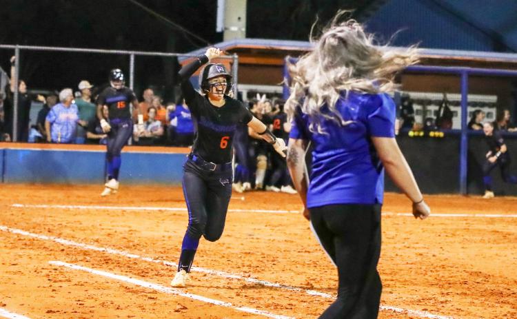 Branford third baseman Madyson Sikes celebrates running to first base after hitting a walk-off home run to defeat Fort White in the Region 3-1A championship on Tuesday. (BRENT KUYKENDALL/Lake City Reporter)