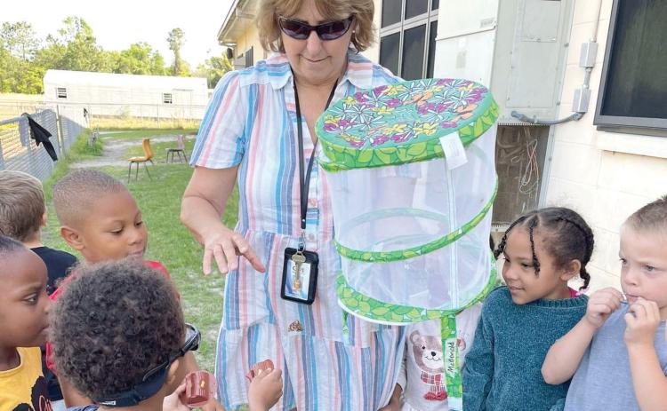 Summers Elementary School VPK teacher Karen McDonald works with students outside of the school. The Summers VPK program earned a perfect state score. (COURTESY))
