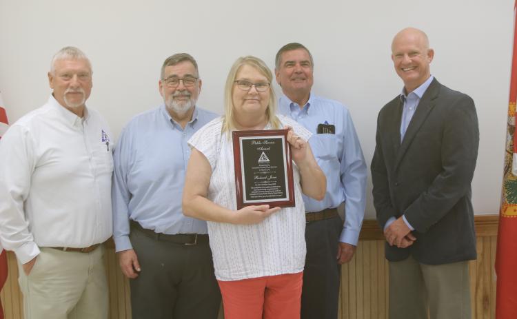 Greg Harden (from left), David Kraus, Steven Dicks and Jeb Smith stand with Lynn Jones after she received the Outstanding Public Official of the Year plaque in honor of her late husband, Richard Jones. (TONY BRITT/Lake City Reporter)