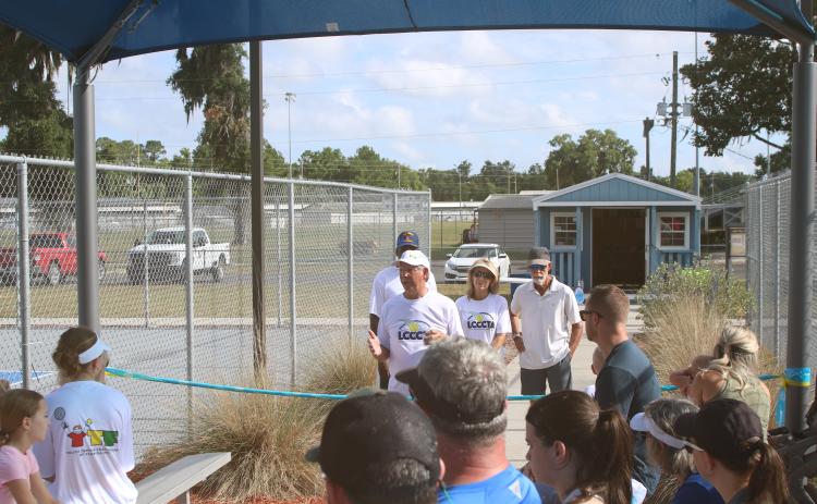 Mike Null, the president of the Lake City Columbia County Tennis Association, talks about the tennis courts at Youngs Park and the shade structure that was dedicated Thursday morning. (TONY BRITT/Lake City Reporter)