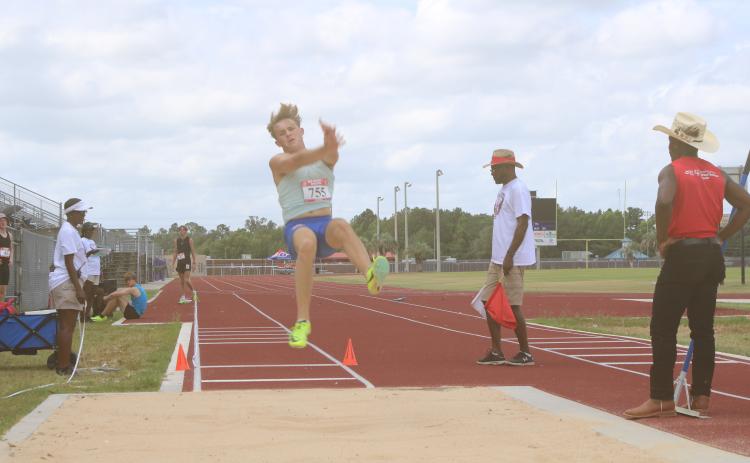 Colin Maxwell, a 17-year-old from Jacksonville, competes in the long jump Thursday during an AAU regional championship at the Columbia High School track. (TONY BRITT/Lake City Reporter)