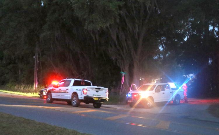 Deputies with the Columbia County Sheriff’s Office search along County Road 252 on Wednesday night for an armed suspect from a robbery at the Dollar General on SW Main Blvd. (MORGAN MCMULLEN/Lake City Reporter)