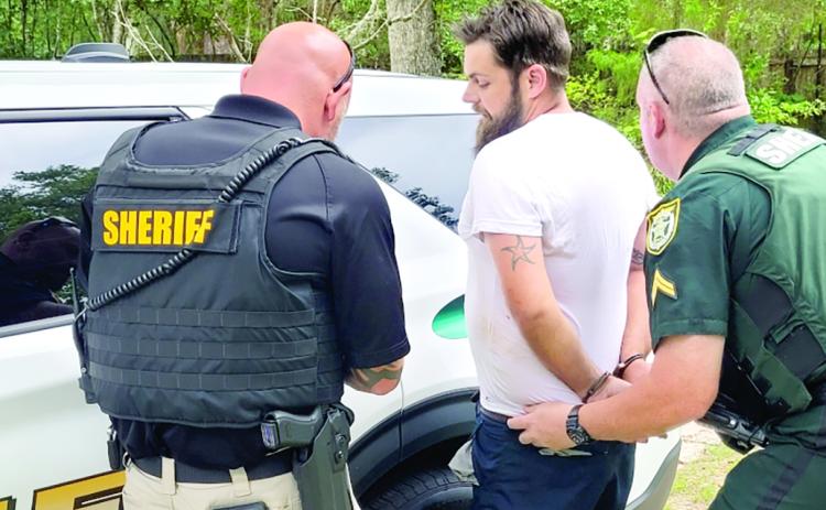 Matthew Gooch is taken into custody by the Columbia County Sheriff’s Office after being accused of firing 10-plus shots into a residence Wednesday morning. (COURTESY CCSO)