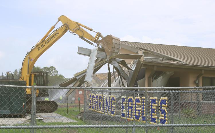 Crews began knocking down the office area at Niblack Elementary School on Wednesday as demolition is underway to create room for a new school on the site. (TONY BRITT/Lake City Reporter)