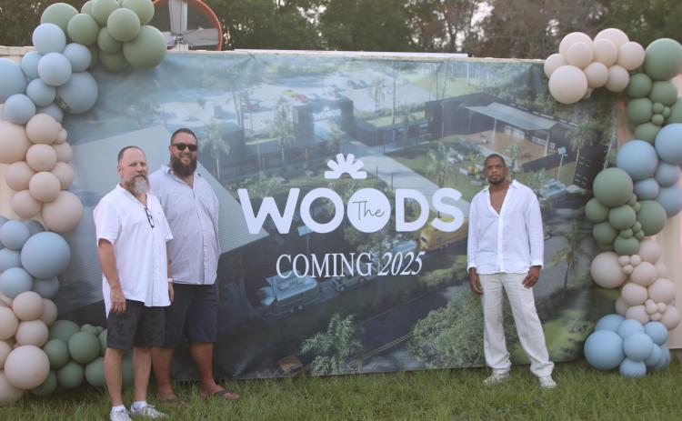 Jimbo Haley (from left) visits with James Crenshaw and Michael Woods, president and CEO of The Woods, about the opening of the unique outdoor venue. (TONY BRITT/Lake City Reporter)