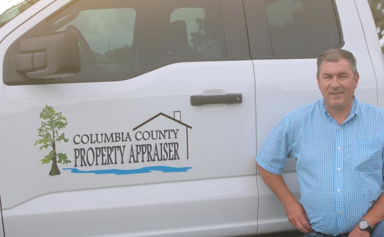 Columbia County Property Appraiser Jeff Hampton shows off the office’s new logo, which has been added to the sides of the employees’ trucks to make them easier to identify. (TONY BRITT/Lake City Reporter)