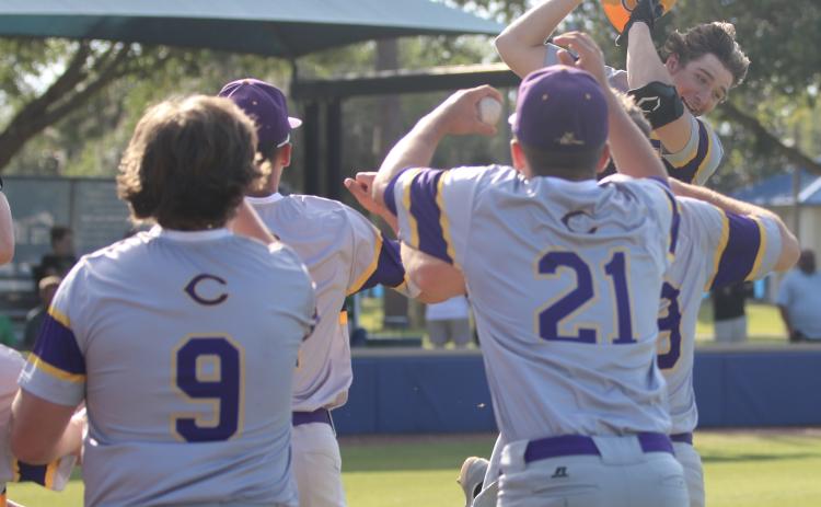 Columbia High’s Ayden Phillips celebrates with teammates after hitting a two-run home run against The Villages Charter this past spring. (FILE)