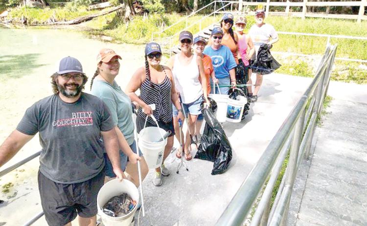 Billy Golightly (from left), Jennifer Golightly, Sandy Kishton, Missy Zecher, Becky Smallwood, Angela Cox, Rhaiza Faulkner, Ginny Smith and Lynda Granoff pose for a photograph after spending time participating in a recent cleanup effort at Rum Island Park. (COURTESY)