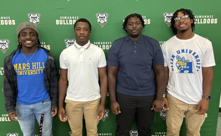 Suwannee’s Marquavious Owens (from left) signed his letter of intent Tuesday to compete in football and weightlifting, while PJ Davis signed with LaGrange College to play baseball, Justice Leggett signed for weightlifting at Warner University and Ja’Darius Cherry signed to play football at Allen University. (COURTESY)