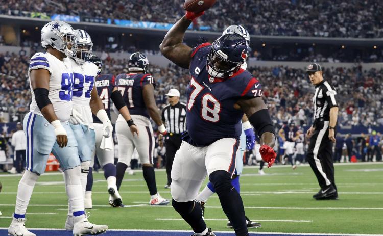 Houston Texans offensive tackle Laremy Tunsil (78) spikes the football after following his team’s touchdown against the Dallas Cowboys at AT&T Stadium on Dec. 11, 2022, in Arlington, Tex. (TOM FOX/TNS)