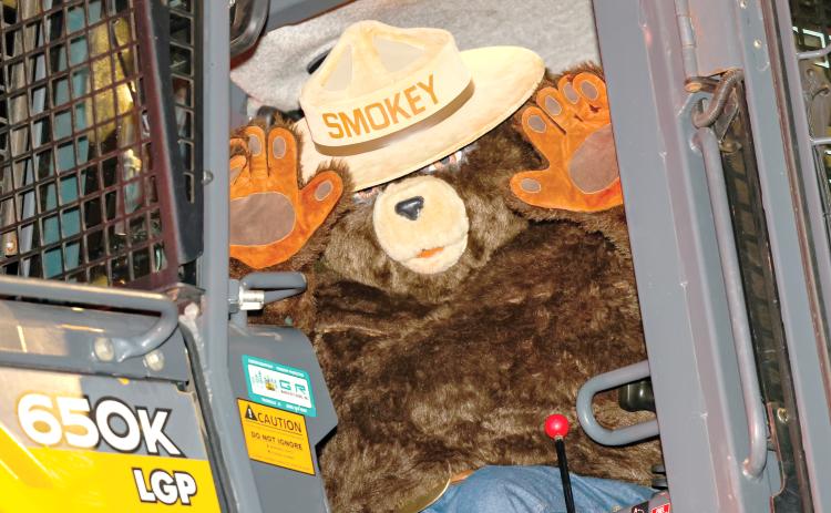Smokey Bear, waving during the Lafayette County Christmas parade last winter, will be celebrating his 80th birthday at Alligator Lake Park on Saturday. (JACK HOWDESHELL/Special to the Reporter)