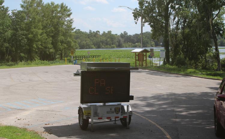 A digital sign sits in the parking lot at Campbell Park and Lake Mongtomery alerting residents that the park will be closed beginning Tuesday for construction of a new fishing pier on the lake. (TONY BRITT/Lake City Reporter)