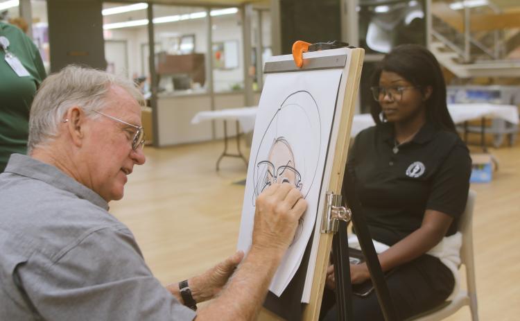 Dino Casterline draws a caricature of Chans Barner on Monday afternoon during Florida Gateway College’s first day of classes for the fall semester. (TONY BRITT/Lake City Reporter)