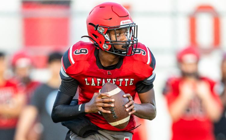 Lafayette quarterback Tywan Williamson rolls out to pass against Tyalor County during the teams’ spring game on May 23. (JACK HOWDESHELL/Special to the Reporter)