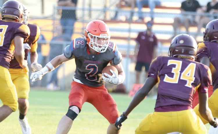 Branford running back Trevor Maddox looks for room to run against Crescent City during a three-team preseason jamboree on Aug. 16. (MORGAN MCMULLEN/Lake City Reporter)