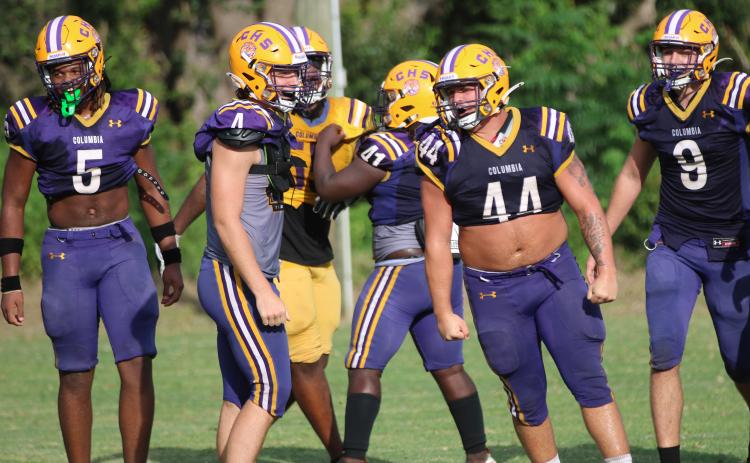 Columbia defensive lineman Caden Bolstein (44) celebrates after making a tackle alongside teammates Jalen Gaskins (5), Ayden Phillips (4) and Kyten Davis (9) during Wednesday’s practice. (JORDAN KROEGER/Lake City Reporter)