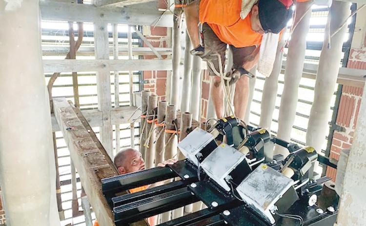 Workers install new bells in the carillon tower at Stephen Foster Folk Culture Center State Park. (COURTESY)