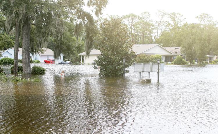 Homes in the Tara Trace subdivision in Live Oak are surrounded by water as the neighborhood is flooded following Hurricane Debby. (TONY BRITT/Lake City Reporter)