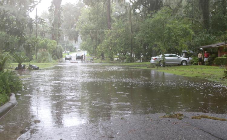 Flood waters cross over SE Inglewood Avenue in Lake City on Monday afternoon after Hurricane Debby dumped up to 16 inches of rain on the area. (TONY BRITT/Lake City Reporter)
