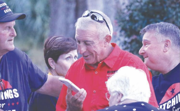 Wallace Kitchings (center) speaks on the phone after learning he’d won the race to be the next Columbia County Sheriff on Tuesday. Now, Kitchings says he’s invested in building relationships with the community. (JAMIE WACHTER/Lake City Reporter)