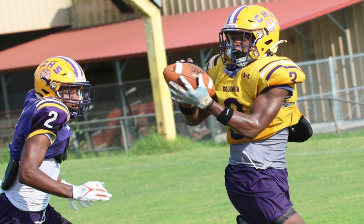 Columbia receiver Zamarion Jones (3) catches a pass ahead of defensive back Vondarius Lane (2) during Wednesday’s practice. (JORDAN KROEGER/Lake City Reporter)